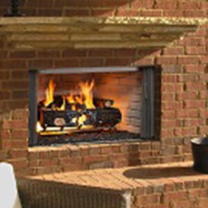 Brick outdoor fireplace with burning fire logs.