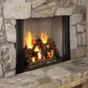 Stone fireplace with burning logs and flames.