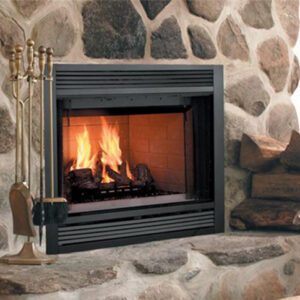 Stone fireplace with burning logs and tools.