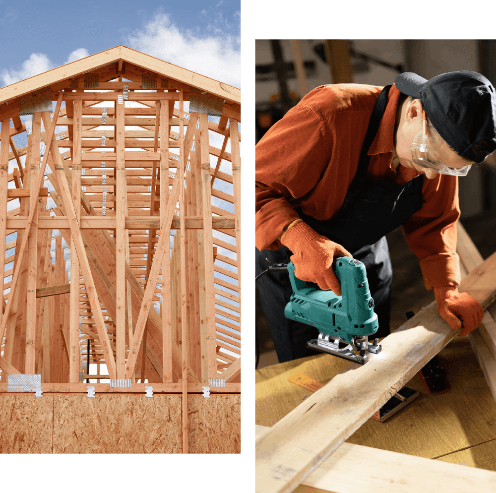 Wooden house frame and person using jigsaw.