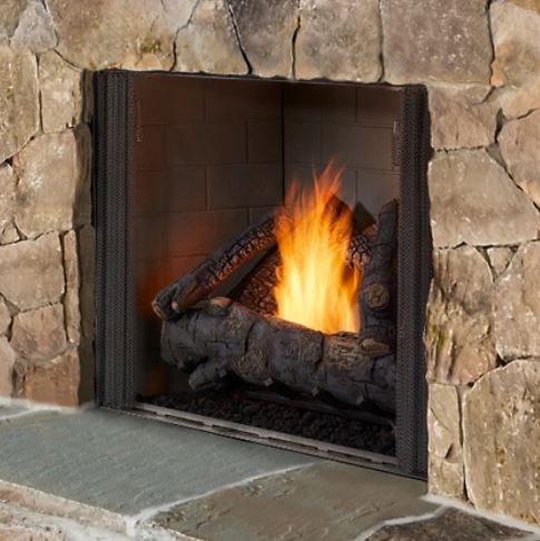 Stone fireplace with a burning fire inside.